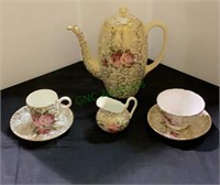 Six pieces of bone china tea pot set, saucers