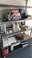 All office supplies on shelf unit (binders, paper