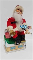 VINTAGE BATTERY OPERATED SANTA ON ROOF BANK