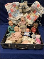 Vintage suitcase with dolls, clothes and blankets
