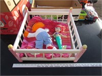 wooden doll bed and dolls