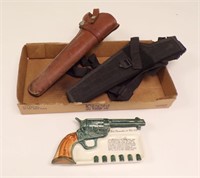 (2) HOLSTERS (ONE IS LEATHER) & CERAMIC COLT 45...