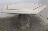Marble-top dining table on cement base