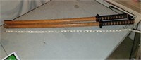 2 wooden swords with black handles approx 39