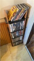 Large lot of DVDs in stand