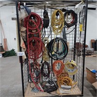 Rack full of extension cords & hoses