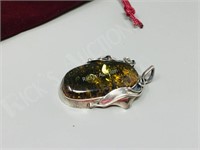 2" long Amber pendant encased in silver