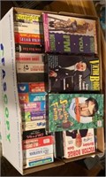 Box of VHS tapes. Mostly comedy