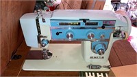White sewing machine in cabinet