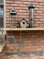 assorted bird feeders and house