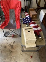 camp table, chair, flag pole set, and birdhouses