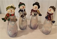 4 snowman singing and playing a instrument