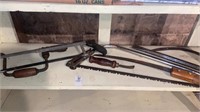 Shelf lot of saws and tools