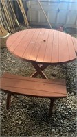 Round wooden picnic table with 2 benches