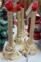 4 single lighted window candles