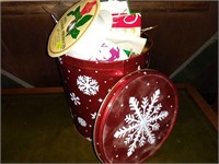 Holiday tin with ribbon and wrapping paper