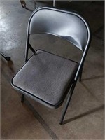 Black metal folding chair dent in backrest