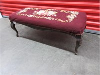 An Ottoman With Needle Point Upholstery