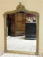 Rococo Flourish Crowned Giltwood Beveled Mirror.