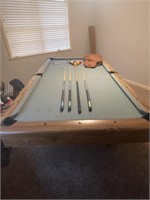 Pool table with full set of billiards balls and