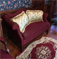 RED SETTEE WITH OVERSTUFFED PILLOWS