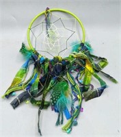 Green and blue dream catcher with ribbons and
