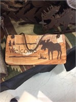 Stone moose welcome sign