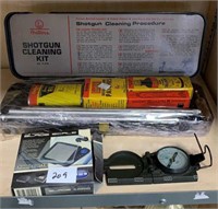 Shotgun cleaning kit, blade scale, and a compass