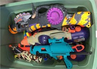 Tub full of nerf, super soaker, and other guns