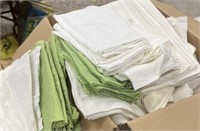 large assortment of table clothes and napkins