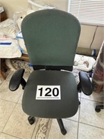 Green material office chair on wheels