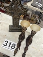 Wooden cross and lighted sconces