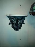 ornate cast iron wall shelf with marble top