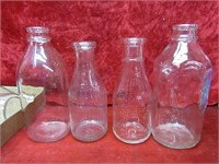 (4)vintage milk bottles.
