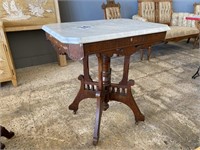 ANTIQUE MARBLE TOP TABLE ON CASTERS 28” X 20”