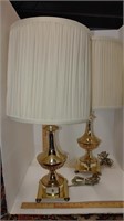 pair of yellow gold lamps with cream shades