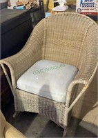 Wicker arm rocking chair with a cushion seat