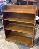 Four level bookshelf with a step back top.