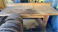 Large handmade workbench with a backboard and a