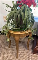 Small gold side table with a planter bucket and