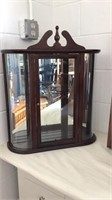 Mirrored display cabinet with rounded glass sides
