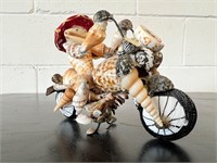 Seashell man riding motorcycle