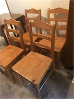 Four wooden ladder back chairs