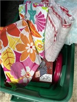 tote with table cloths and plastic plates