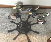 Group of ducks and metal ship wheel decor