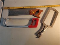pair of hand saws and a clamp