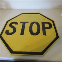 Vintage embossed yellow steel stop sign.