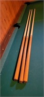 three Winston cue sticks