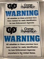 Pair of crime prevention warning signs each