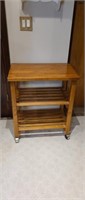 Wooden rolling kitchen cart with slat shelves,